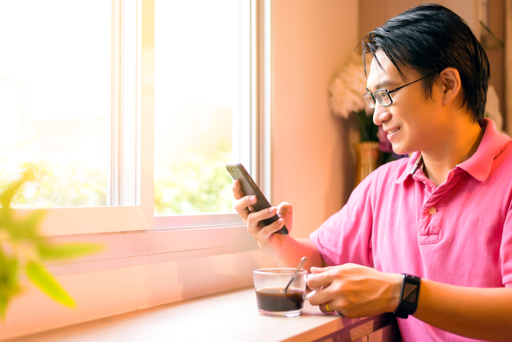 Man Reading Content On His Phone