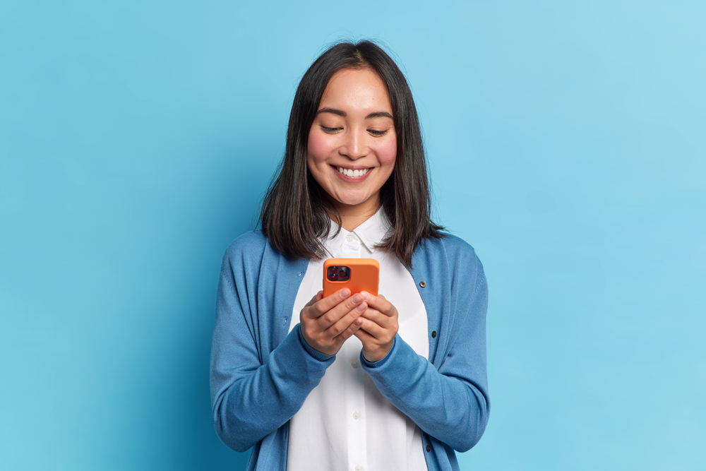 a woman looking at a website on her mobile phone