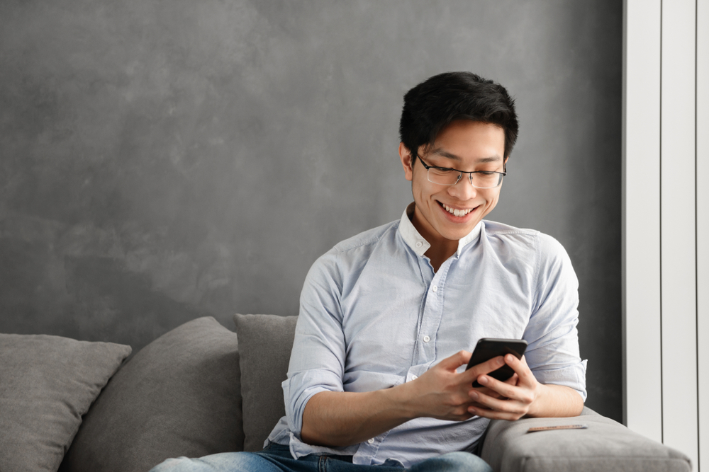 man using a phone to visit a website with responsive design