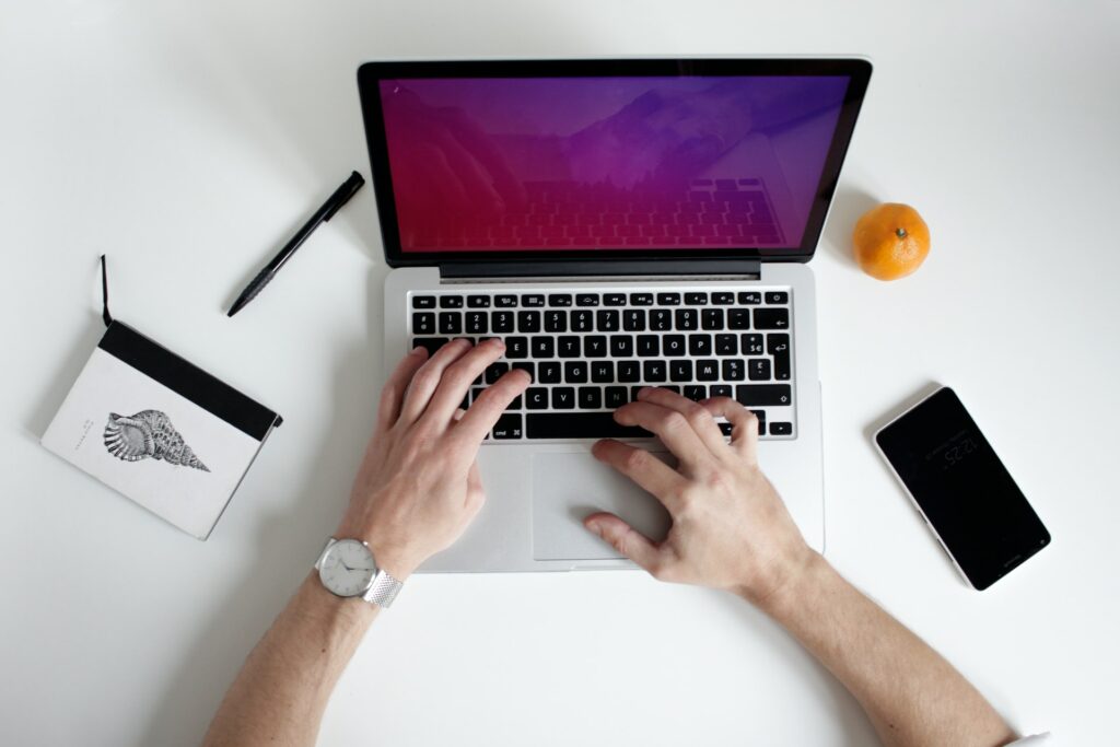 hands typing on a laptop