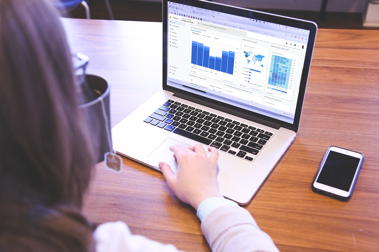 woman looking at the laptop screen showing google analytics dashboard of website traffic