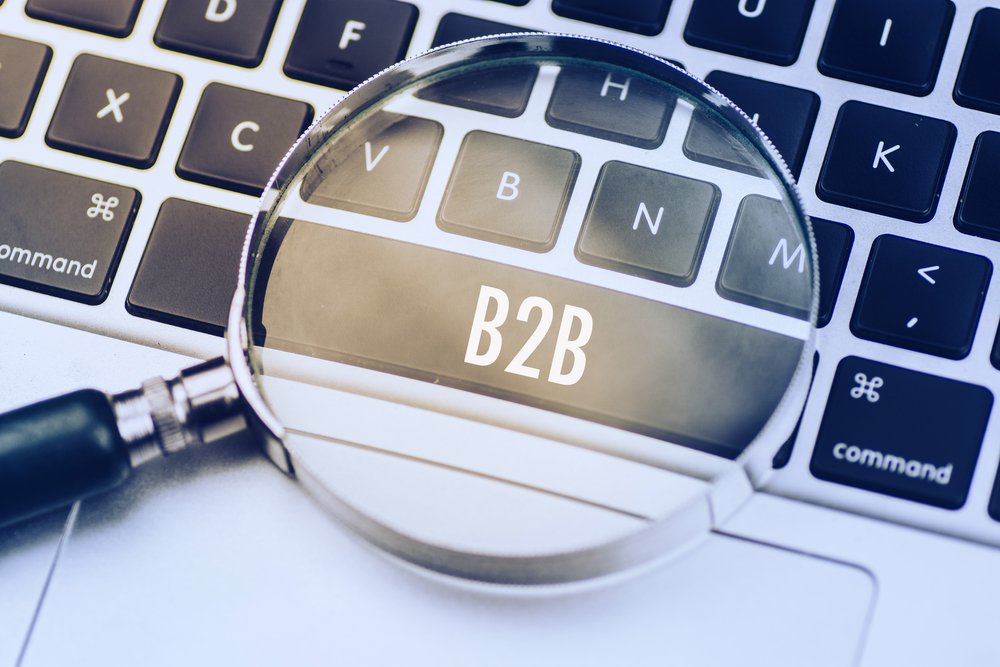 magnifying glass and B2B text in a laptop's space bar