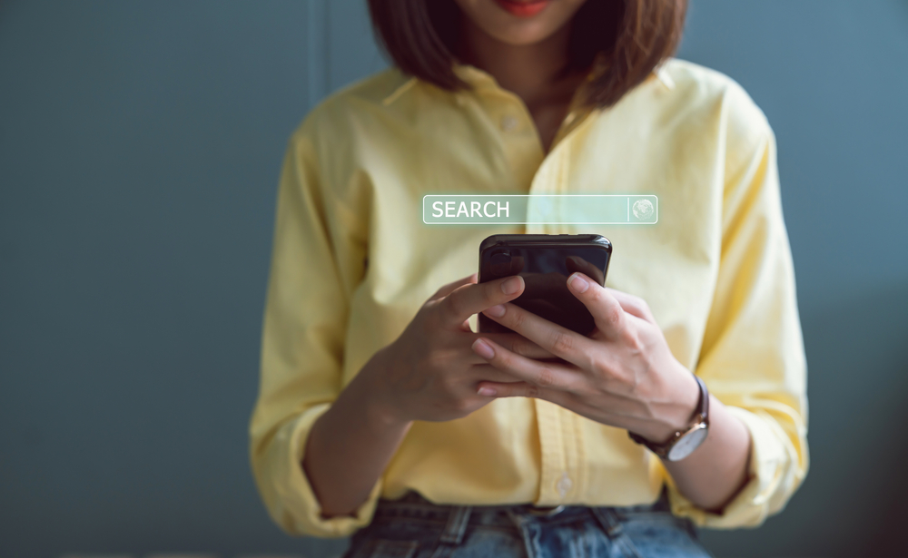 woman doing a search in a browser using her mobile phone