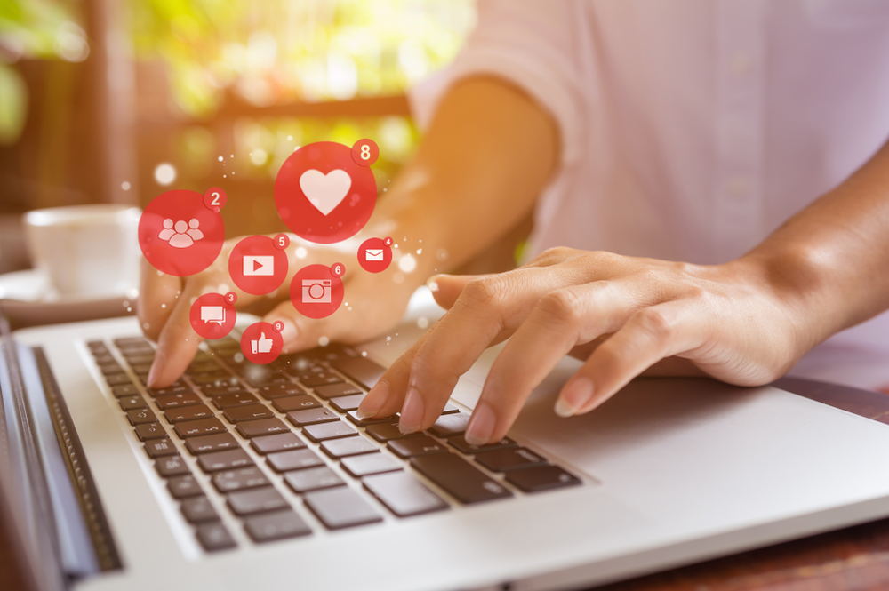 woman handling different social media platforms and sending out emails