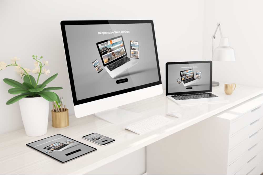 responsive website design shown in a tablet, mobile phone, pc monitor, and a laptop