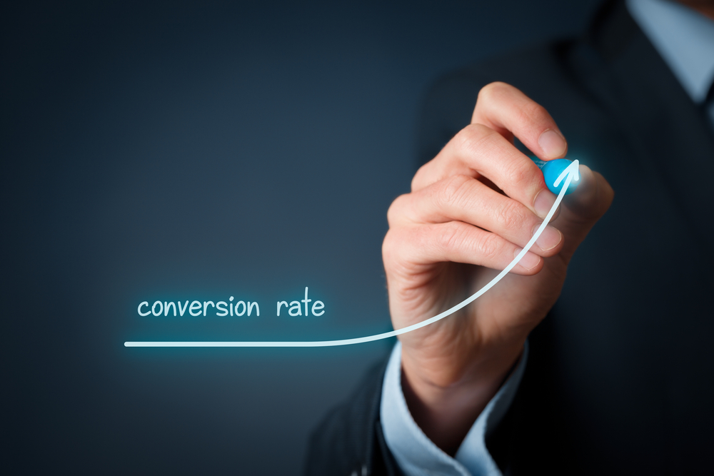 a man is drawing a growing graph of conversion rate