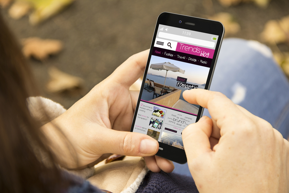 woman reading a blog using a mobile phone