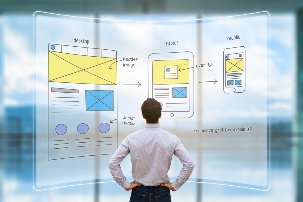 UI and UX front end designer reviewing sketched wireframe layout design