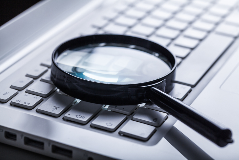 magnifying glass on top of laptop keyboard