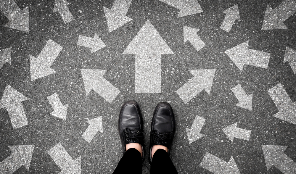 feet of a man on floor with arrows pointing to different directions