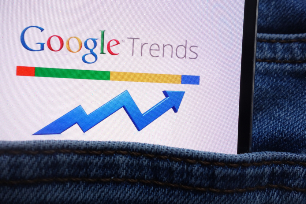 Google Trends logo displayed on smartphone hidden in jean pocket