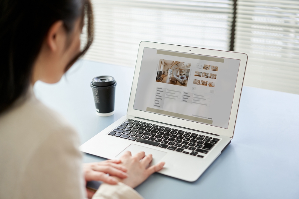 Asian women viewing real estate websites on a computer